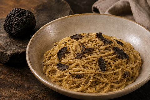 Tagliolini with fresh Tuber melanosporum shavings and a whole Black Truffle