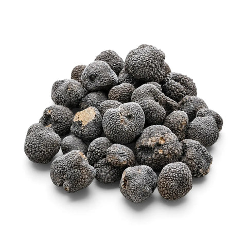 Frozen whole truffles with light natural frost on a white background