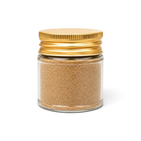 Black summer truffle powder (Tuber aestivum) in a clear glass jar with a yellow lid