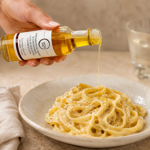 Black Truffle Olive Oil being drizzled over warm creamy tagliatelle