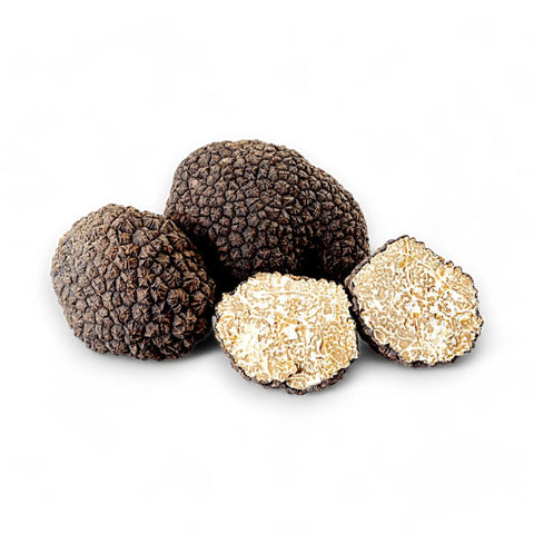 Black truffles, whole and sliced.