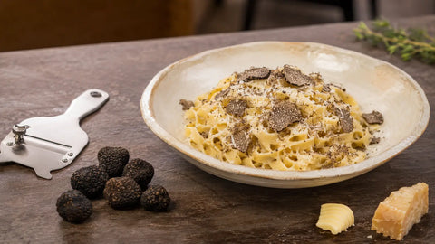 Fresh Tuber aestivum B Grade truffles grated over creamy tagliatelle