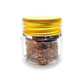 Brown dried spring truffle Tuber borchii in glass jar with gold lid for gourmet cooking