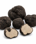 Whole and cut fresh Tuber aestivum A Grade truffles with pale hazelnut interiors and fine marbling