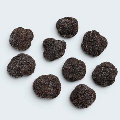 Frozen whole black truffles shown as a year-round culinary format