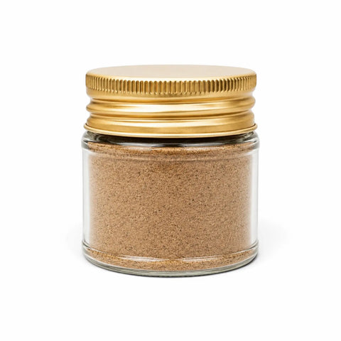 Spring white truffle powder (Tuber borchii) in a clear glass jar with a yellow lid